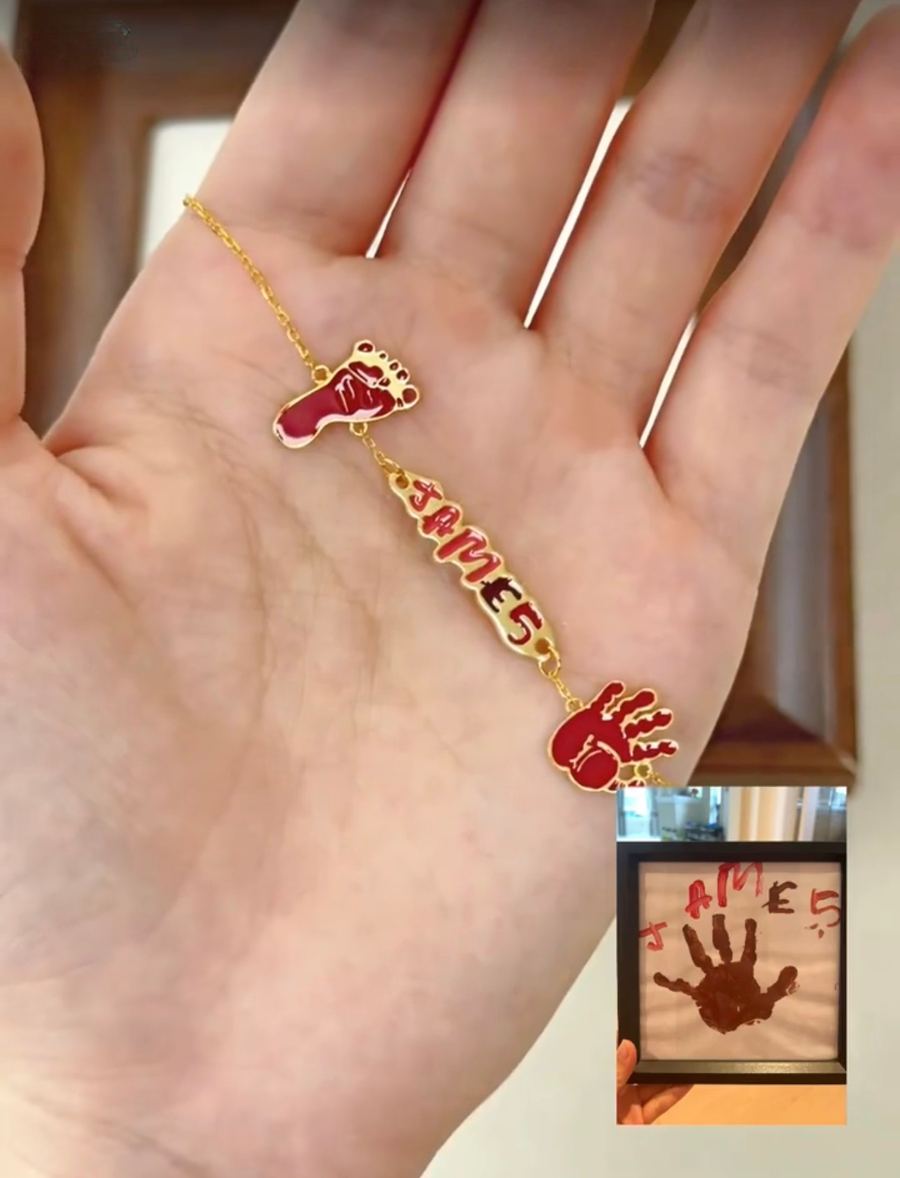 Newborn hand and footprints with the name James as a gold bracelet