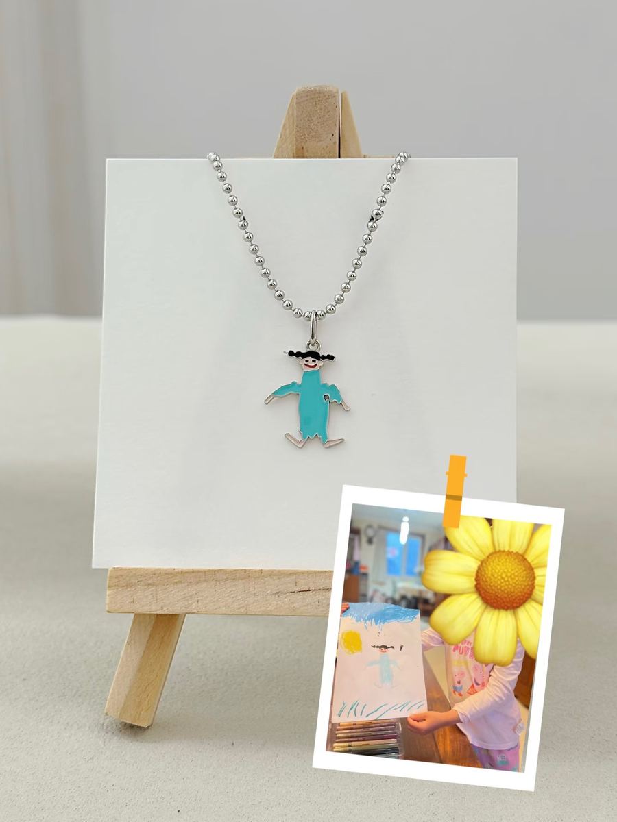Girl's drawing of herself as a turquoise silver pendant
