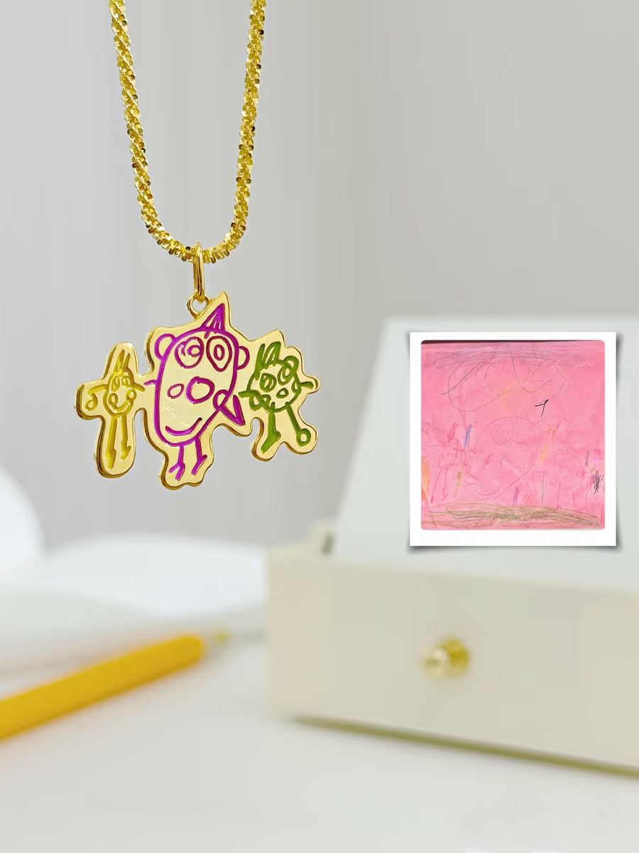 Pink scribble as a gold pendant of three little creatures